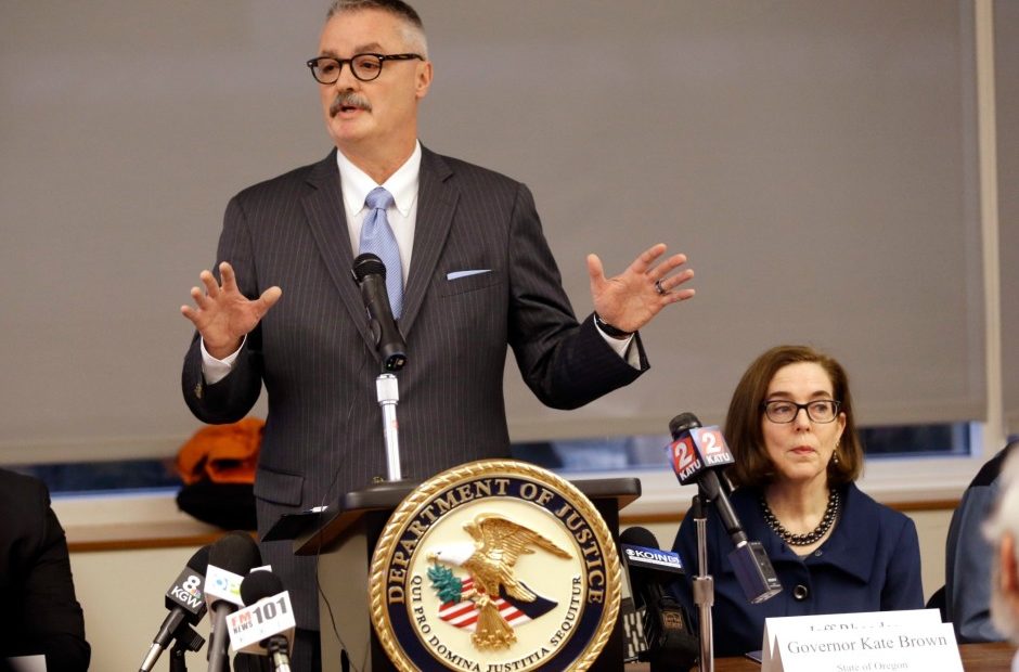 U.S. Attorney for the District of Oregon Billy J. Williams, left, speaks at a marijuana summit in Portland, Oregon, Friday, Feb. 2, 2018, as Oregon Gov. Kate Brown sits at right. CREDIT: DON RYAN