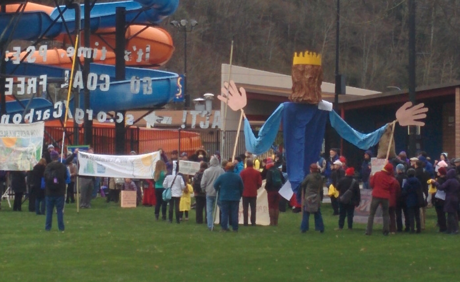 Activists gather outside the Renton Community Center to protest Puget Sound Energy's plan to continue using electricity from coal.