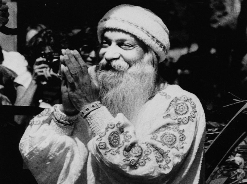 Bhagwan Shree Rajneesh greets his followers, the Rajneeshees, during a daily afternoon drive-by in one of his Rolls-Royce cars in Rajneeshpuram, Ore., on Aug. 18, 1984. CREDIT: BILL MILLER/AP