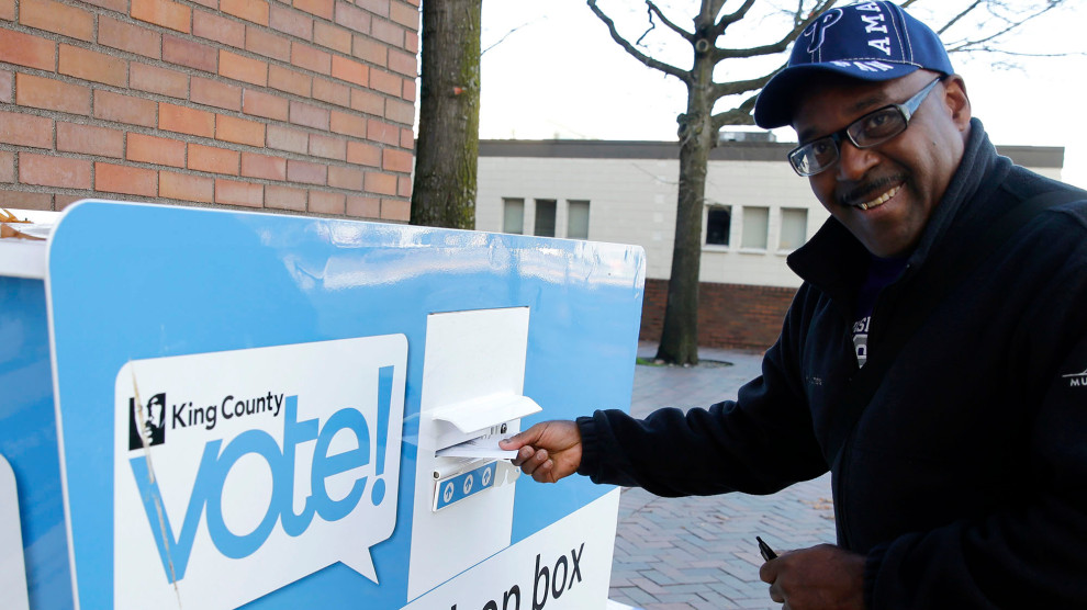 Gus Clark deposits his vote-by-mail ballot in a collection box in Seattle in the 2016 election. CREDIT: TED S. WARREN/AP