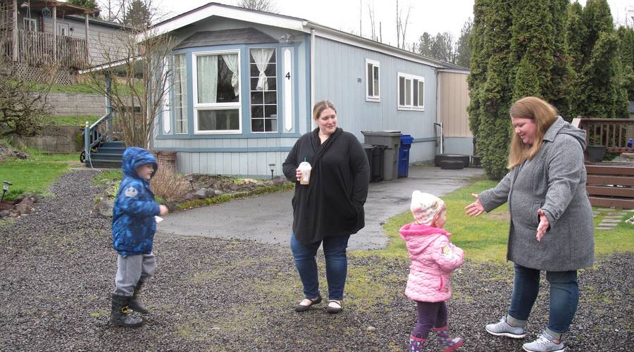 Next-door neighbors and Duvall Riverside Village homeowners Stephanie Rosevear (L) and Danelle Knapp (R) return home from a walk.