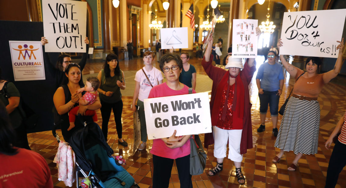 When Iowa Gov. Kim Reynolds signed Iowa's new abortion bill into law, protesters gathered outside her office at the Statehouse in Des Moines. Two groups have now filed a lawsuit to block the bill. CREDIT: Charlie Neibergall/AP