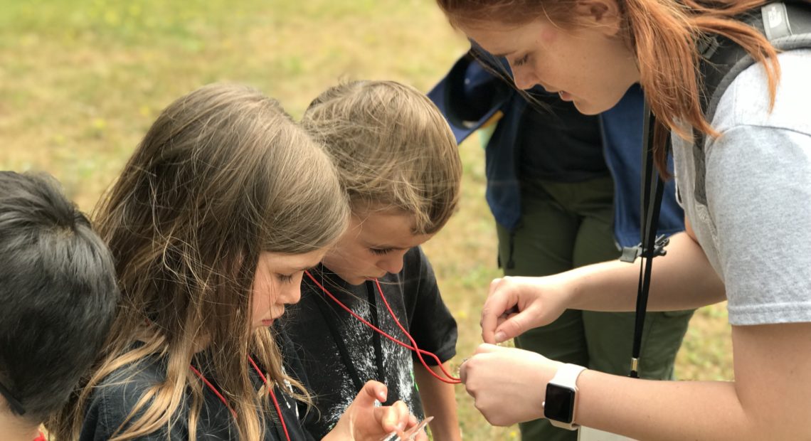 Amy Miseli, here teaching map and compass skills to Cub Scouts, plans to attend the BSA Boot Camp at Camp Thunderbird. Courtesy of Amanda Lafferty