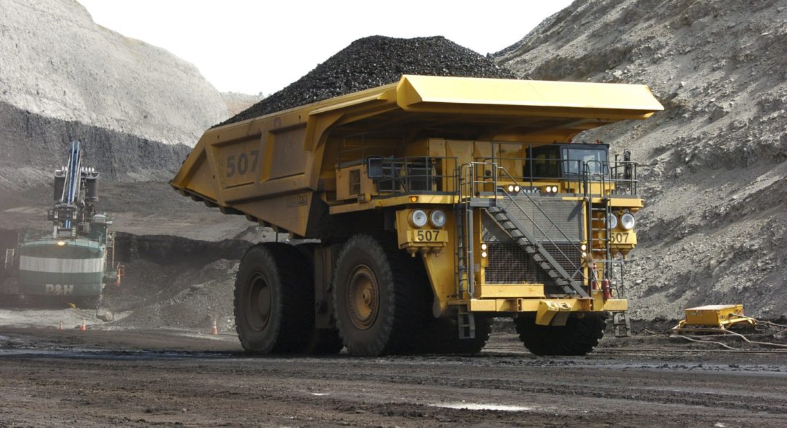 FILE - In this April 4, 2013, file photo, a mining dumper truck hauls coal at Cloud Peak Energy's Spring Creek strip mine near Decker, Mont. The Trump administration is considering using West Coast military bases or other federal properties as transit points for shipments of U.S. coal and natural gas to Asia. CREDIT: MATTHEW BROWN