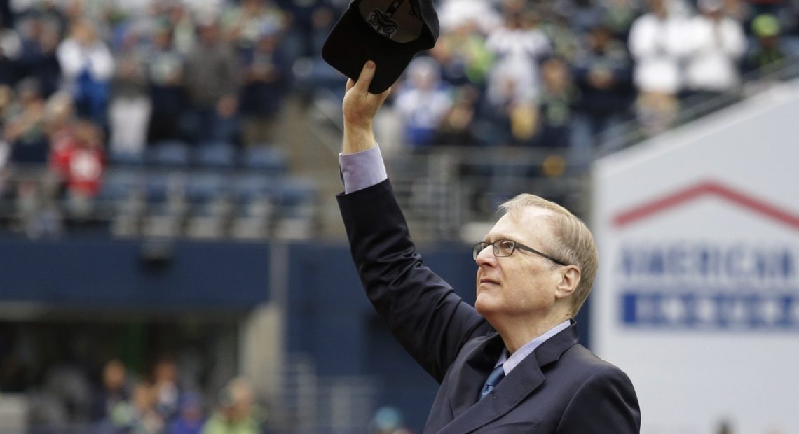 Seattle Seahawks owner Paul Allen tips his cap to fans as he is honored for his 20 years of team ownership before an NFL football game against the San Francisco 49ers, Sunday, Sept. 17, 2017, in Seattle. CREDIT: ELAINE THOMPSON