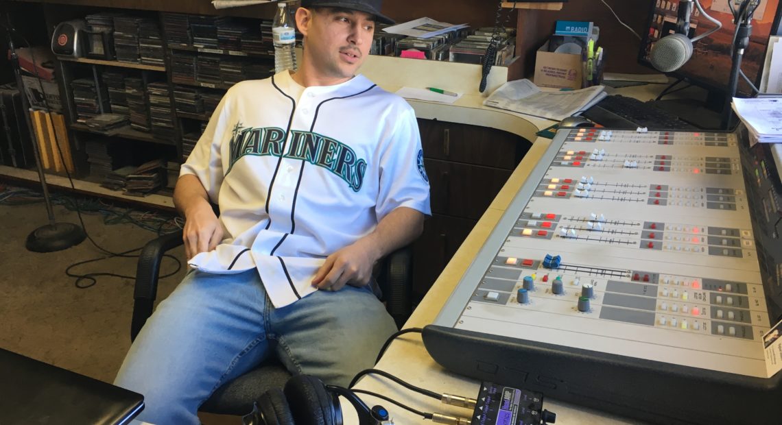 KYNR host Ryan Craig at the station in February 2018, in front of the audio board that was stolen in October. CREDIT: Esmy Jimenez/NWPB