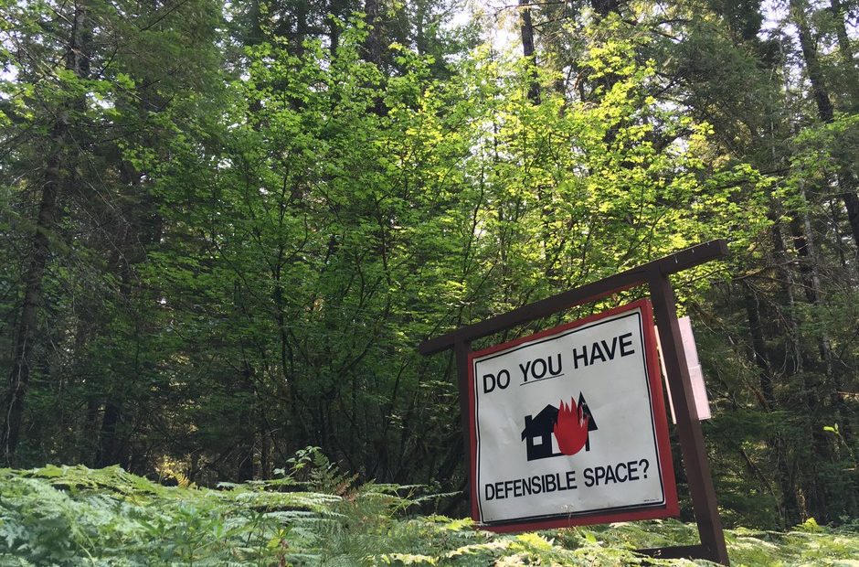 A roadside reminder in southwest Washington's Gifford Pinchot National Forest that homes in the "wildlands urban interface" need special landscaping, building materials and maintenance to reduce the risk of being destroyed by a wildfire. CREDIT: CASSANDRA PROFITA