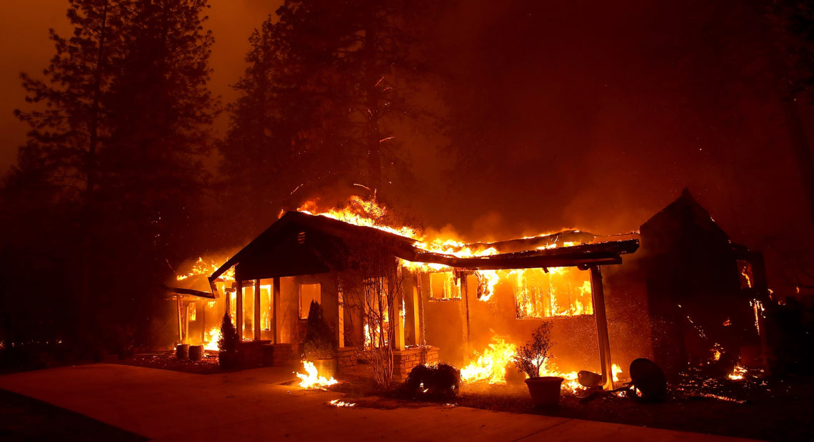 A home burns as the November 2018 Camp Fire moved through Paradise, Calif. Fueled by high winds and low humidity, the rapidly spreading fire killed 85 people and burned nearly 19,000 building in Butte County, making it the state’s deadliest and most destructive fire in modern times. CREDIT: Justin Sullivan/Getty Images