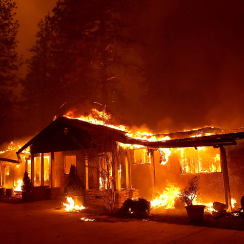 A home burns as the November 2018 Camp Fire moved through Paradise, Calif. Fueled by high winds and low humidity, the rapidly spreading fire killed 85 people and burned nearly 19,000 building in Butte County, making it the state’s deadliest and most destructive fire in modern times. CREDIT: Justin Sullivan/Getty Images