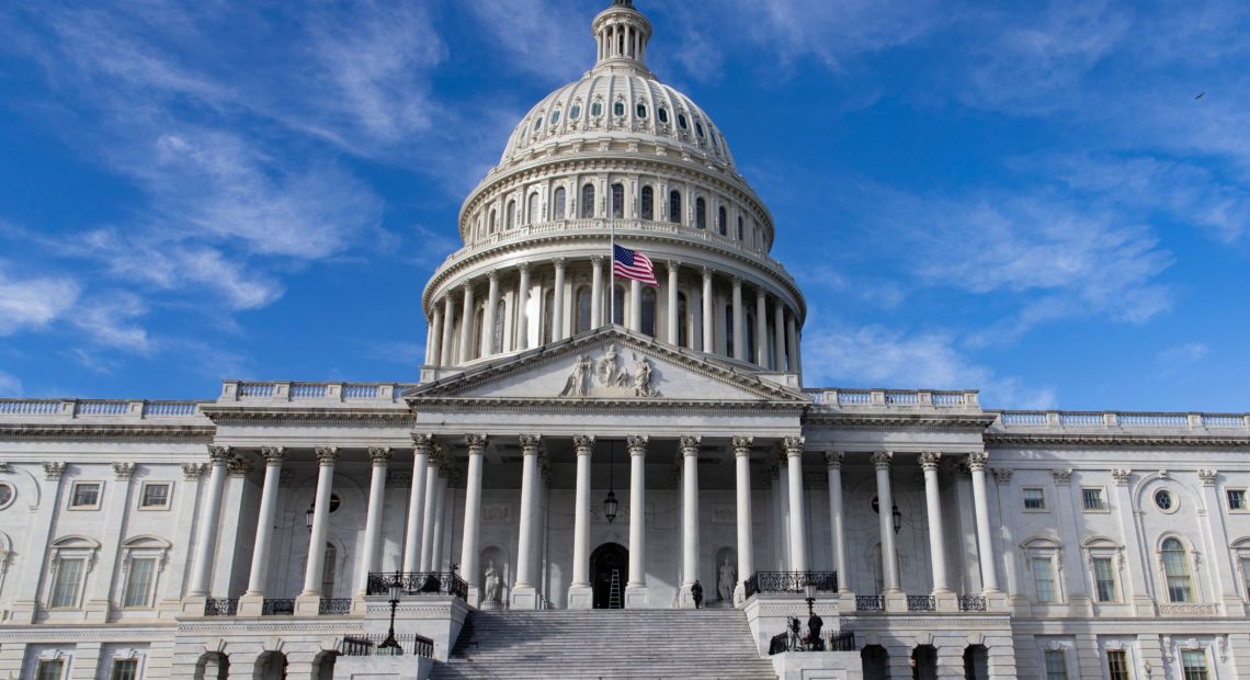 The U.S. flag flies at half-staff in honor of former President George H.W. Bush outside the Capitol in Washington, D.C., Monday. Top Hill leaders planned on a stopgap funding bill to avoid a partial shutdown at the end of the week. CREDIT: Alex Edelman/AFP/Getty Images