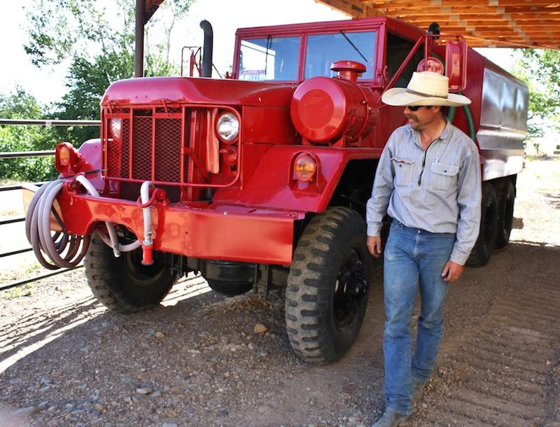 A water tender for fighting wildfires is parked next to rancher Charlie Lyon’s barn near Mountain Home, Idaho. CREDIT: JESSICA ROBINSON/N3