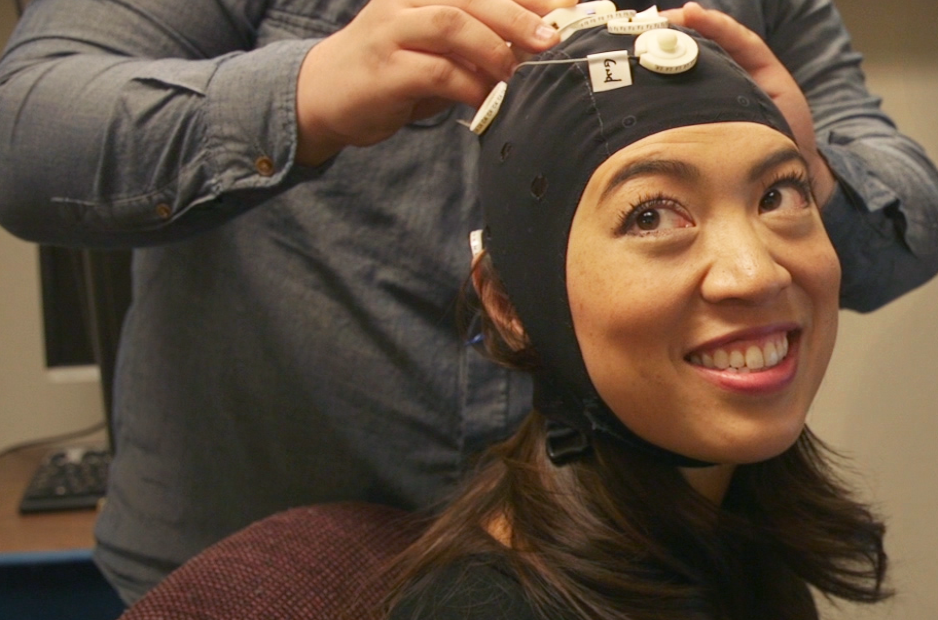 NPR's Elise Hu wears a cap that connects her to a network of other people playing a Tetris-like game at the University of Washington's Center for Neurotechnology.