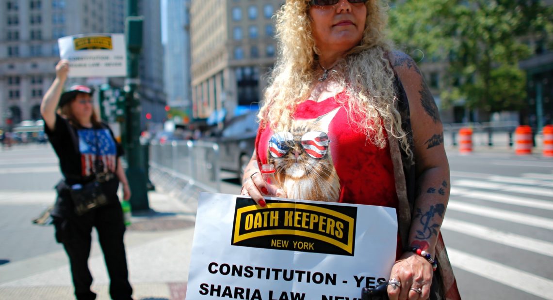 A woman holds up a sign during an anti-Sharia law rally organized by ACT for America. A new report finds that mainstream philanthropies are unknowingly funneling donations to anti-Muslim groups such as ACT for America. Kena Betancur /AFP/Getty Images