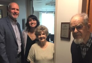 Pinkleton, Dodhia, and the Mattesons pose with dedication plaque