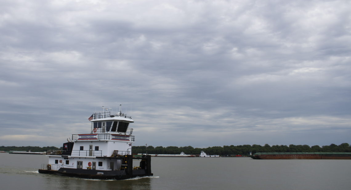 The Shawnee Forest towboat steers down the Ohio River near American Commercial Barge Line's office outside Cairo, Ill. As of June 12, more than 600 barges were waiting to go upstream once water levels dropped.. CREDIT: Madelyn Beck/Illinois Newsroom