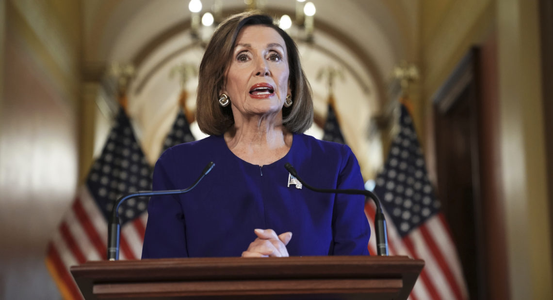 House Speaker Nancy Pelosi reads a statement announcing a formal impeachment inquiry into President Trump on Capitol Hill on Tuesday. Andrew Harnik/AP