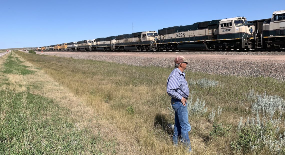 In Gillette, Wyo., miner Bill Fortner stands by stalled trains that normally would be transporting coal. Local production has declined by one-third in the past decade. CREDIT: Cooper McKim/Wyoming Public Media