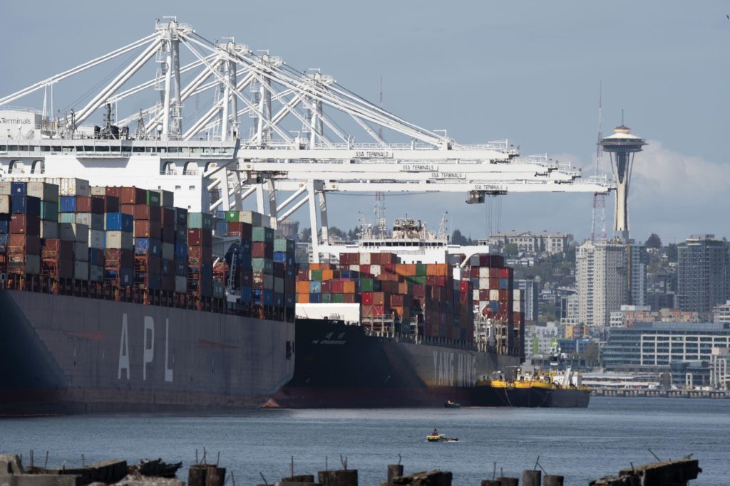 Containers are loaded on ships at Terminal 18 in Seattle April 26, 2019. Hay from the inland Northwest is shipped in containers to destinations around world. CREDIT: Northwest Seaport Alliance