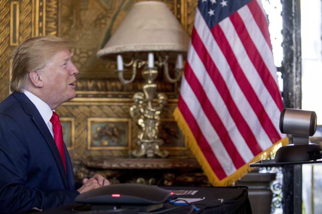 During a Christmas Eve video teleconference, President Trump speaks with members of the military from his Mar-a-Lago estate in Palm Beach, Fla. CREDIT: Andrew Harnik/AP