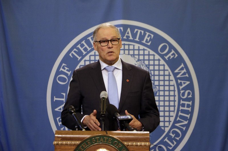 Washington Gov. Jay Inslee talks to news media Jan. 16, 2020, after a state Supreme Court ruling that reinstated a severely limited version of his plan to cap carbon pollution in the state. He said the ruling just strengthens his commitment to get climate change-related bills through the Legislature this year. CREDIT: Rachel La Corte/AP