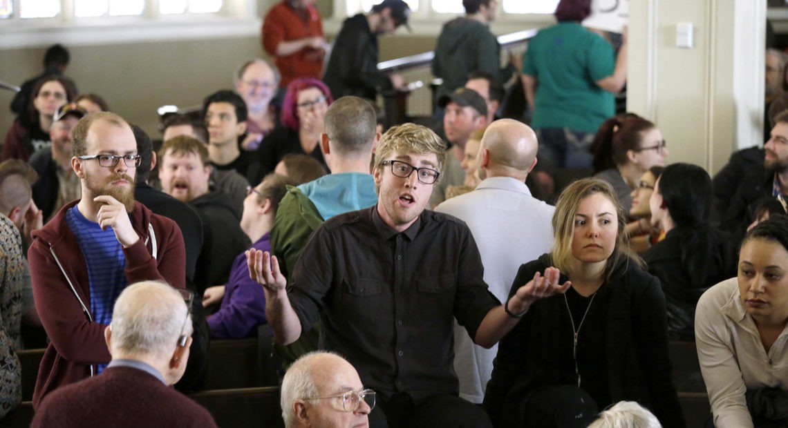 A man speaks in support of a candidate during Washington state's Democratic caucus in 2016 in Seattle. In 2019, the state Democratic party did away with the caucus system and going forward will use only primary elections to select which nominee to support for president. CREDIT: Elaine Thompson/AP