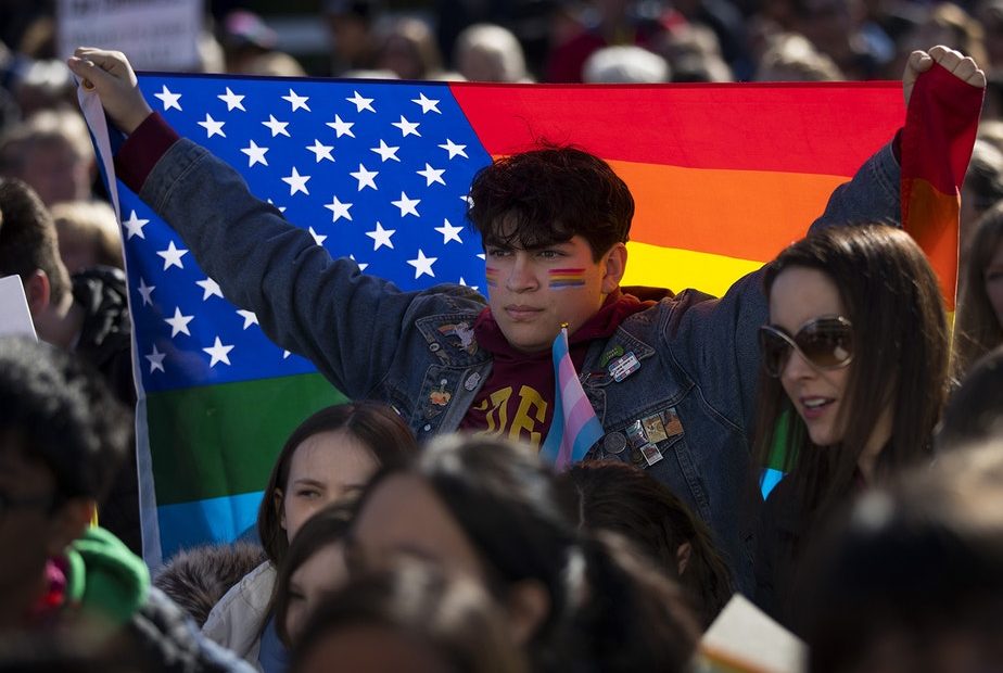 Nicolas Velasquez, 17, holds a rainbow flag during a walkout to protest the departure of two LGBT educators on Tuesday, February 18, 2020, at Kennedy Catholic High School in Burien. "I don't think that it's okay that this is happening now," Velasquez said. "I want to be the change that I want to see."