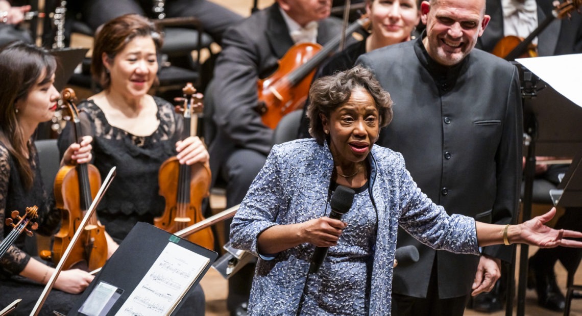 Tania León speaks at the premiere of her piece "Stride," one of 19 pieces composed by women that the New York Philharmonic commissioned to celebrate the 100th anniversary of the 19th Amendment. CREDIT: Chris Lee/Courtesy New York Philharmonic