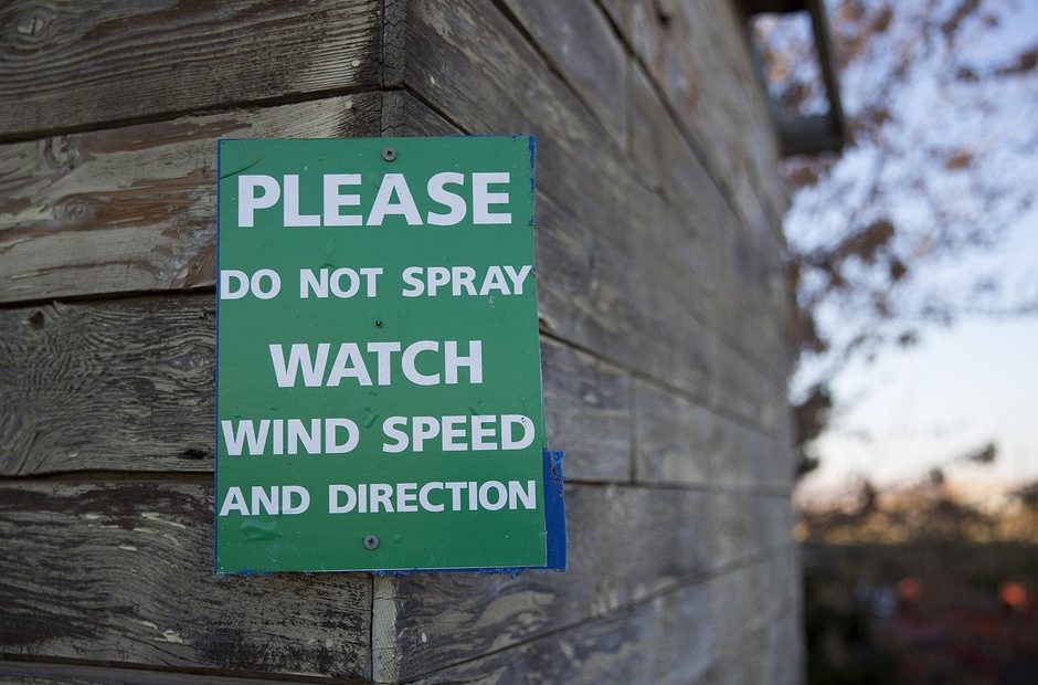 File photo. A sign at the property of Eric and Mari Perez in Qunicy, Washington, where houses are surrounded by apple orchards. Some people don't want the pesticide chlorpyrifos drifting from orchards to their property. CREDIT: Megan Farmer/KUOW