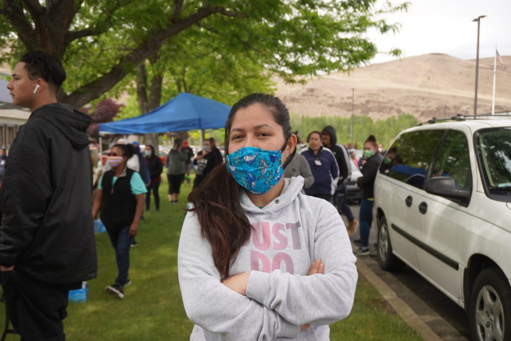 Perla Torres, a fruit packer at Jack Frost Fruit, poses for a photograph wearing a mask she says she bought from a supervisor. CREDIT: Enrique Pérez de la Rosa/NWPB