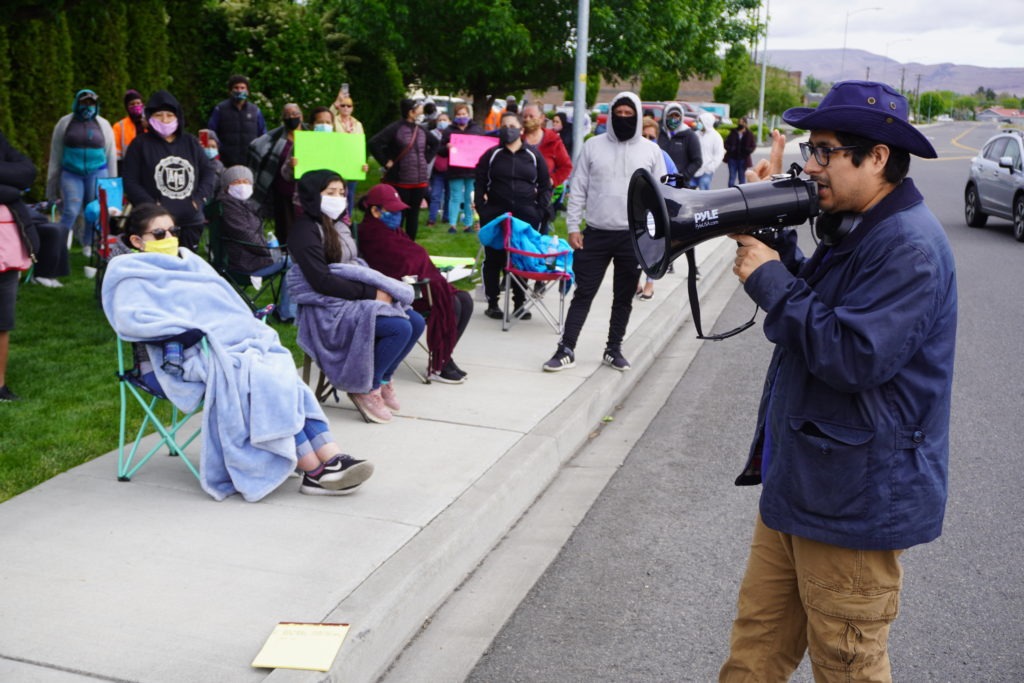 Northwest Justice Project Attorney David Morales addresses striking Matson Fruit workers on May 13 to inform them of labor rights and ask for testimonies of working conditions on the production line. CREDIT: Enrique Pérez de la Rosa/NWPB