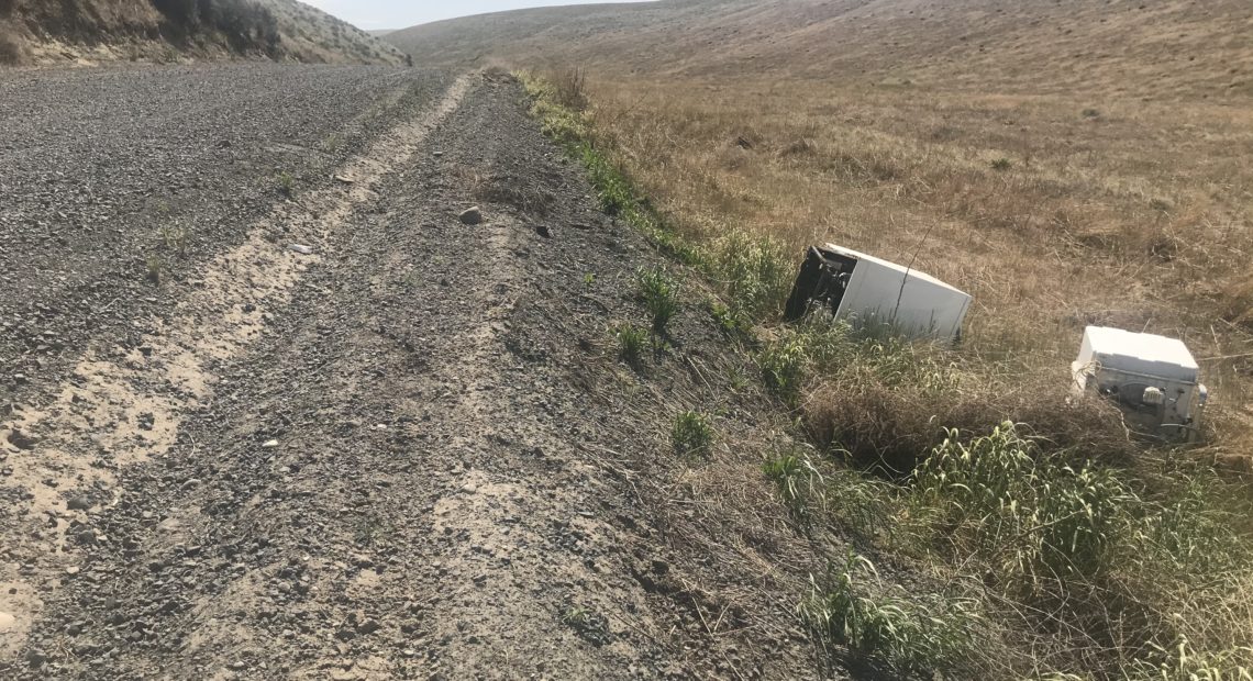 A washing machine was abandoned on the side of the road outside Kennewick. The Washington State Department of Transportation has noticed an uptick in appliances and other junk that’s illegally dumped. (Credit: Courtney Flatt / Northwest News Network)