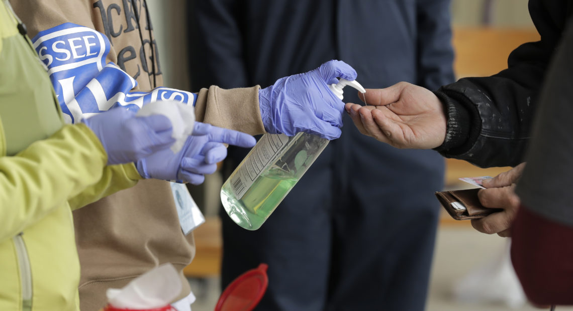 A patient arrives to pick up medication for opioid addiction and is given hand sanitizer at a clinic in Olympia, Wash. The pandemic is changing the distribution networks and supplies of street drugs across the United States, authorities say.