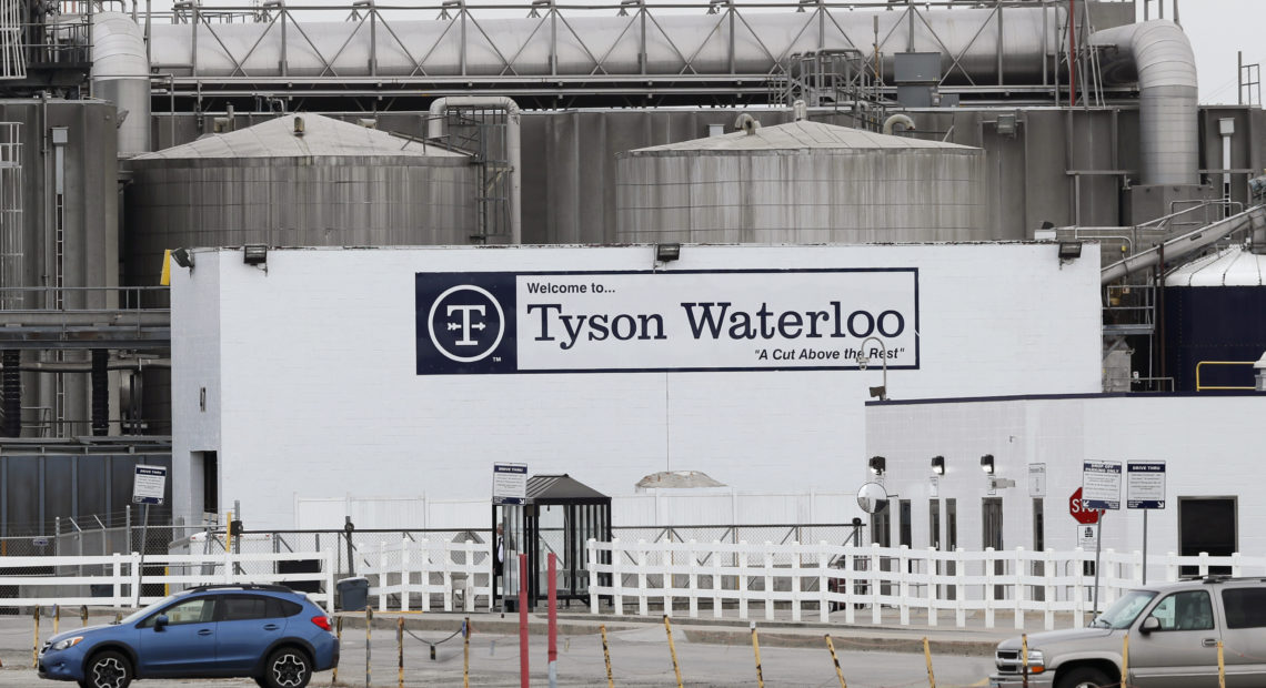 Vehicles sit in a near empty parking lot outside the Tyson Foods plant in Waterloo, Iowa, on May 1. CREDIT: Charlie Neibergall/AP