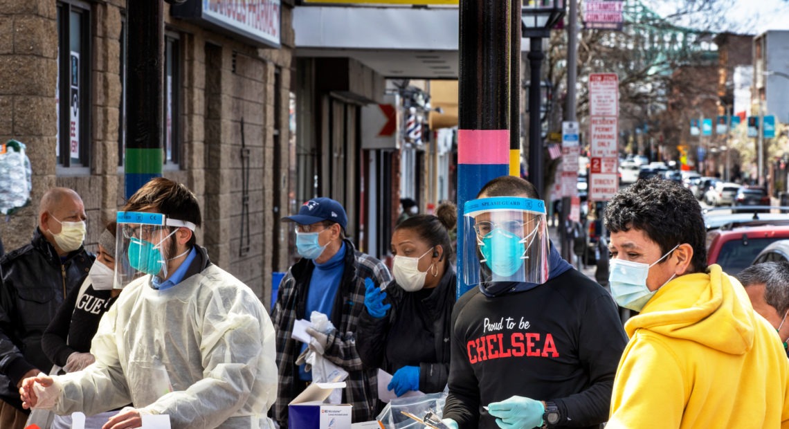 People line up in mid-April in Chelsea, Mass., to get antibody tests for the coronavirus that causes COVID-19.