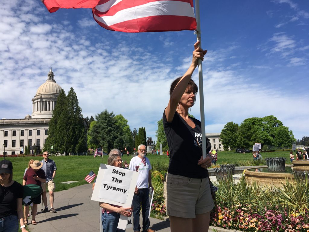 Participants at the Saturday rally prayed as the event got underway. Government overreach and tyranny were common themes. CREDIT: Austin Jenkins/N3