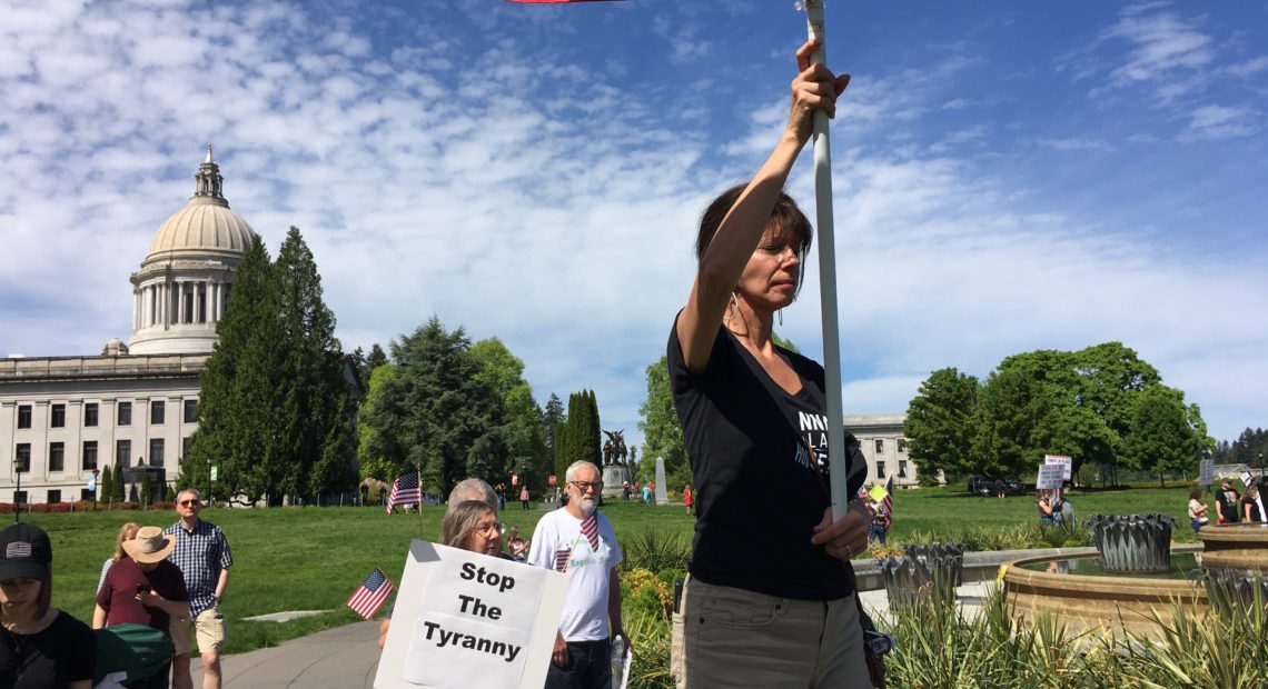 Participants at the Saturday rally prayed as the event got underway. Government overreach and tyranny were common themes. CREDIT: Austin Jenkins/N3