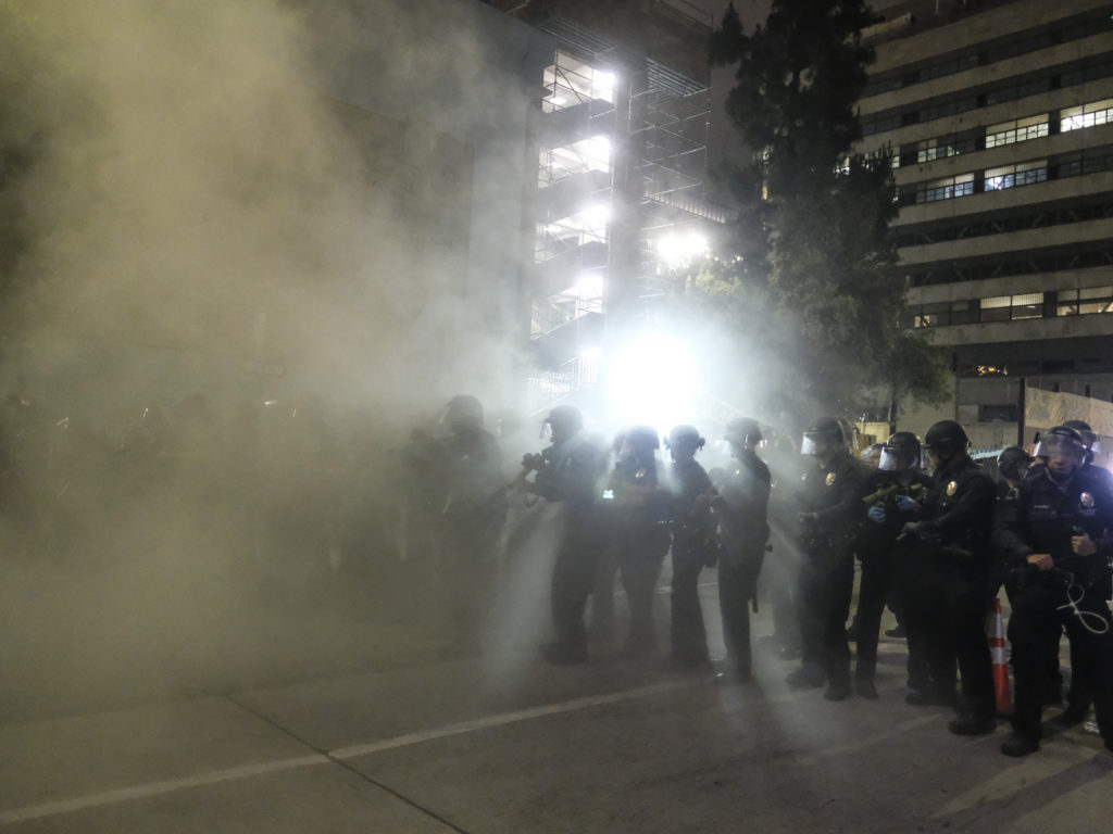 Police officers fire rubber bullets May 29 during a Los Angeles protest over the death of George Floyd. CREDIT: Ringo H.W. Chiu/AP