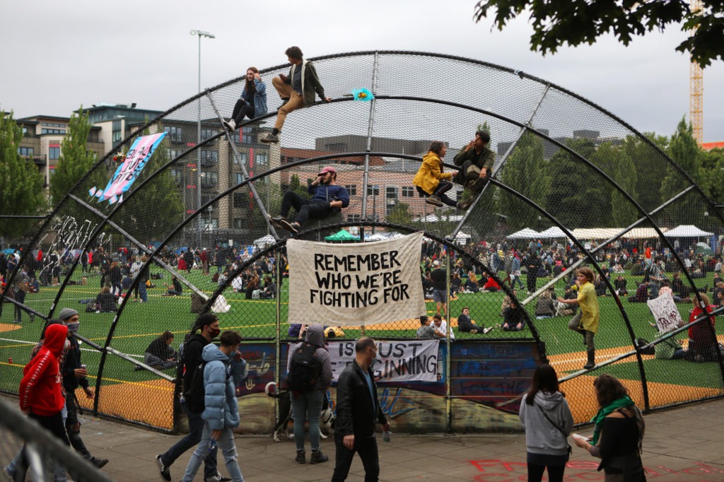 Protesters have established a food co-op, a community garden, medical stations, a speaker's stage, movie nights, book exchanges and round-the-clock security patrols. They see their camp as a prototype for a self-reliant, safe enclave that doesn't need police. CREDIT: Jim Urquhart for NPR