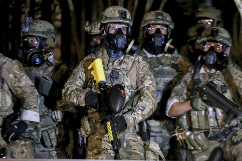 Federal officers deployed tear gas and fired less-lethal rounds into a crowd of protesters late Thursday, July 16, 2020. The actions came just hours after the head of the Department of Homeland Security called the protesters “violent anarchists.” CREDIT: Beth Nakamura/The Oregonian via AP