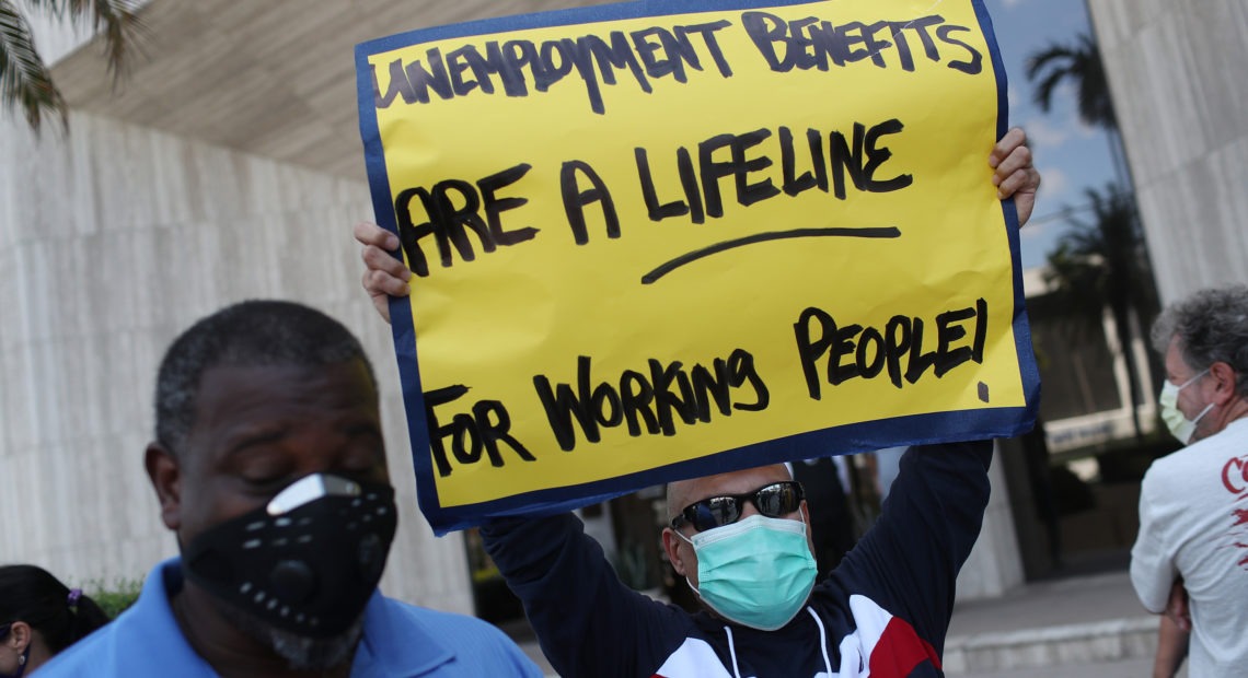 Demonstrators in Florida ask senators to support the continuation of boosted unemployment benefits. Joe Raedle/Getty Images