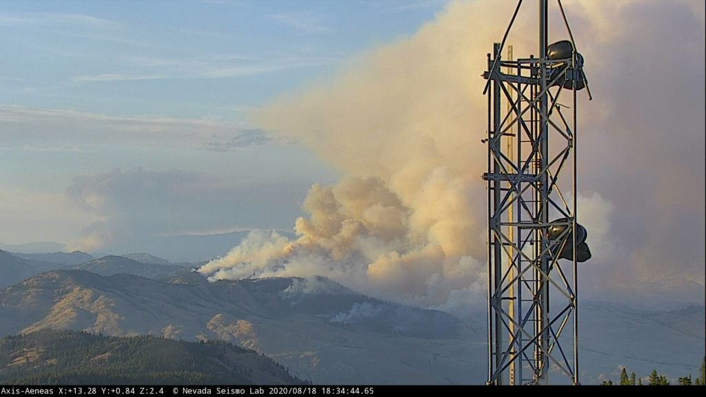 The Palmer Fire in Okanogan County, southwest of Oroville, seen from the Aeneas Mountain Lookout Tuesday evening, Aug. 18, 2020. Smoke from a fire in nearby British Columbia is also visible.