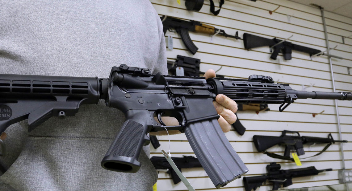 John Jackson, co-owner of Capitol City Arms Supply shows off an AR-15 assault rifle for sale Wednesday, Jan. 16, 2013 at his business in Springfield, Ill. President Barack Obama launched the most sweeping effort to curb U.S. gun violence in nearly two decades, announcing a $500 million package that sets up a fight with Congress over bans on military-style assault weapons and high-capacity ammunition magazines just a month after a shooting in Connecticut killed 20 school children. CREDIT: Seth Perlman/AP