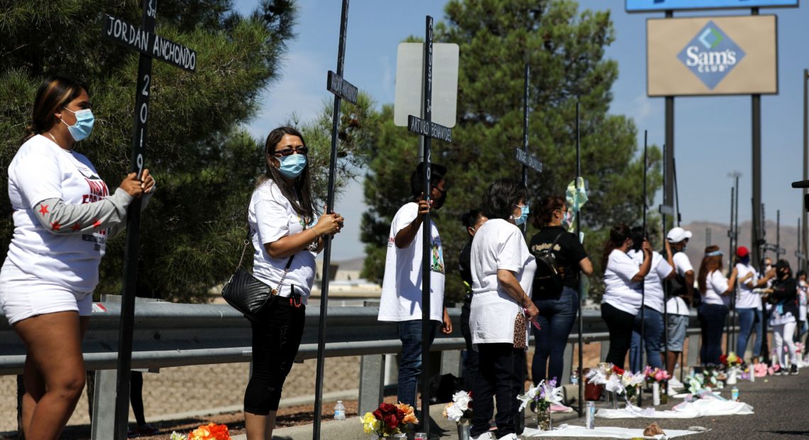 Mourners hold 23 crosses Monday in front of a Walmart honoring those killed in the 2019 attack in El Paso, Texas. CREDIT: Mario Tama/Getty Images