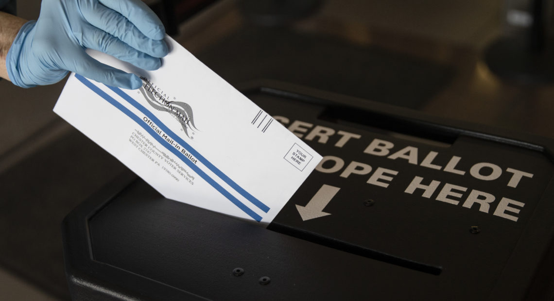 In this May 2020 photo, a voter casts her mail-in ballot at in a drop box in West Chester, Pa., prior to the primary election. On Saturday a federal judge blocked a Trump campaign lawsuit to limit the use of drop boxes in the state. CREDIT: Matt Rourke/AP