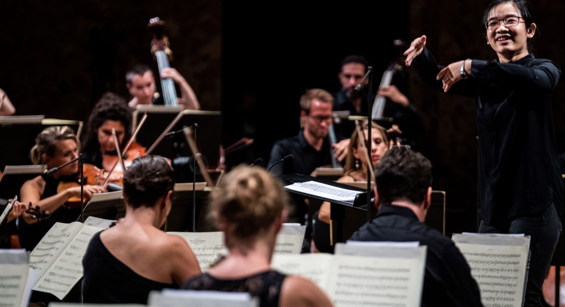 Chinese conductor Jiajing Lai performs in the first edition of La Maestra, an international competition for women conductors, held at the Philharmonie de Paris this September. CREDIT: Martin Bureau/AFP via Getty Images