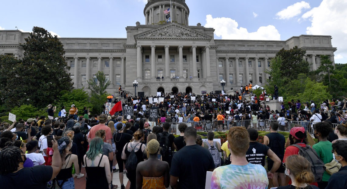 A crowd gathers for a rally to demand justice in the death of Breonna Taylor on the steps of the the Kentucky State Capitol in June. Taylor was killed in her apartment while Louisville police served a warrant. Timothy D. Easley/AP