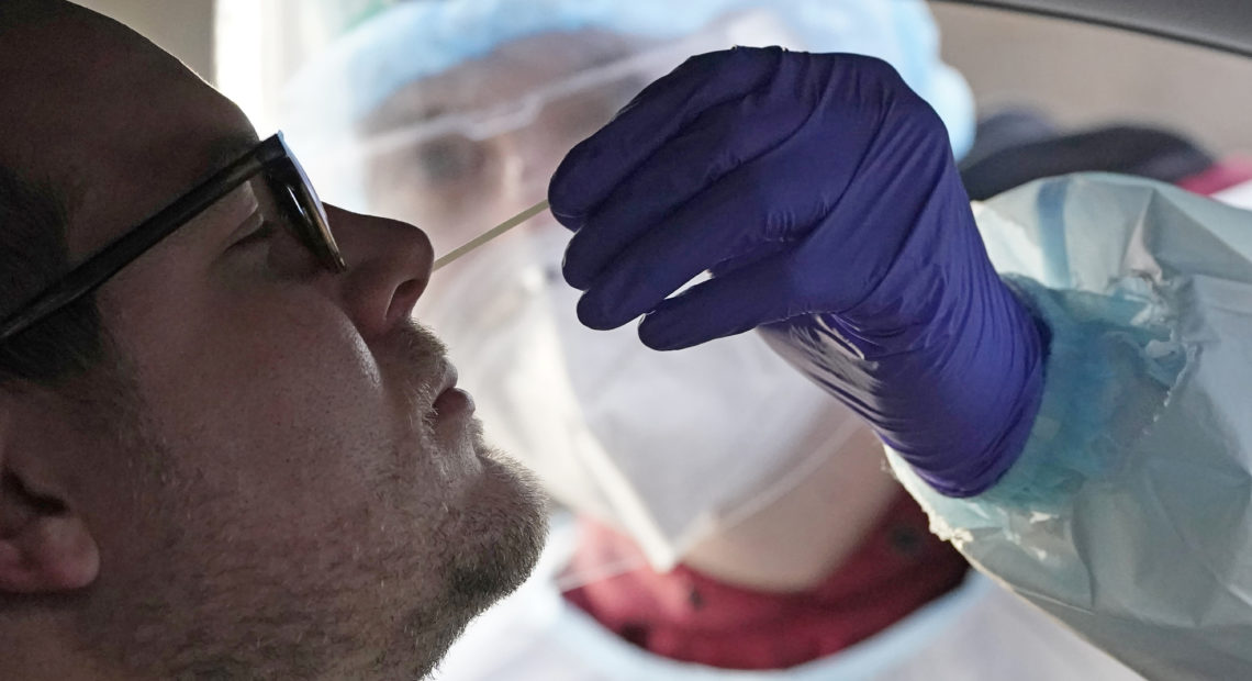 A coronavirus test is administered in Salt Lake City in Tuesday. At-home coronavirus tests will offer faster results than the traditional tests. CREDIT: Rick Bowmer/AP