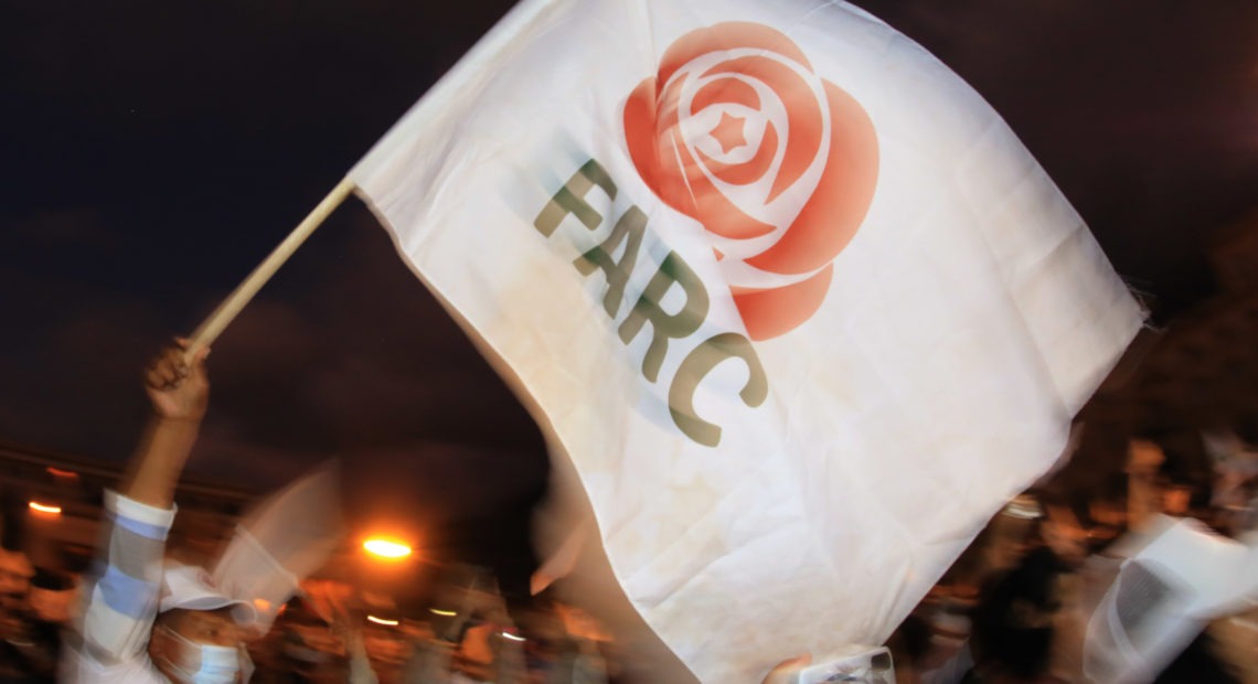 A former FARC guerrilla member waves a FARC political party flag during a demonstration in Bogota on Nov. 2. A federal court overturned an asylum decision Wednesday, holding that FARC death threats counted as persecution.× CREDIT: Daniel Munoz/AFP via Getty Images