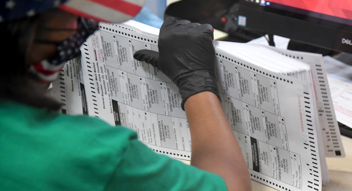 A Clark County election worker scans mail-in ballots on Nov. 7 in North Las Vegas, Nevada. CREDIT: Ethan Miller/Getty Images