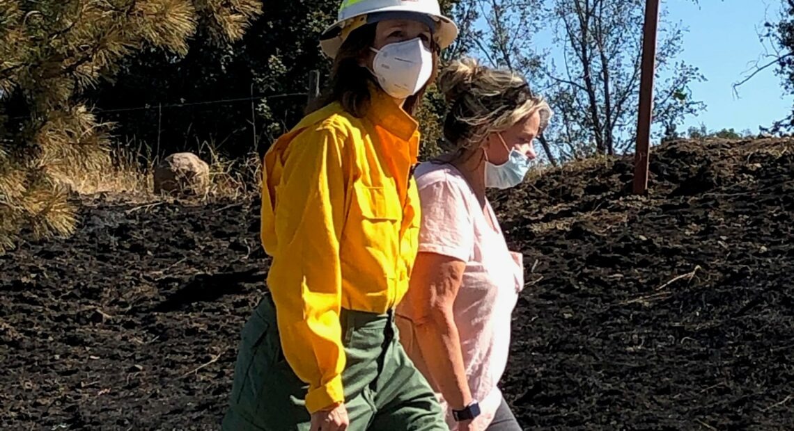 Washington Lands Commissioner Hilary Franz, walking here with former Malden Mayor Chris Ferrell, is working with legislators to find more money for wildfire suppression and prevention. CREDIT: Doug Nadvornick/SPR